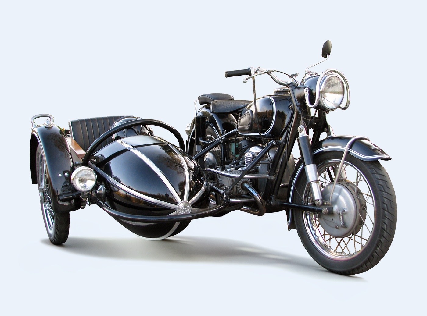 A motorcycle with a sidecar attached, the two built as one machine